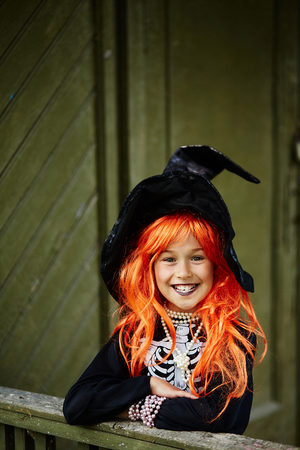 Halloween girl in black hat looking at cameraの写真素材