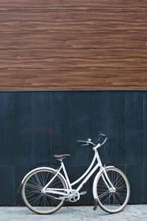 Bicycle by wall of modern buildingの写真素材
