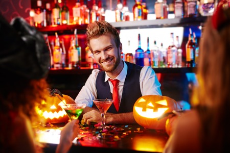 Young handsome bartender working at Halloweenの写真素材