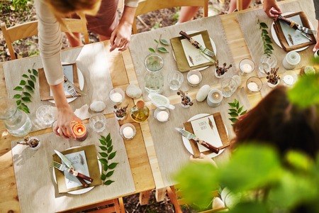 Festive table being served by girlsの写真素材