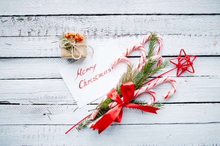 Christmas bouquet, greeting card and small giftbox on wooden backgroundの写真素材