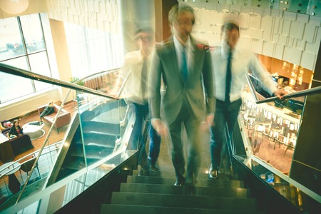 Blurred outlines of business group going upstairsの写真素材