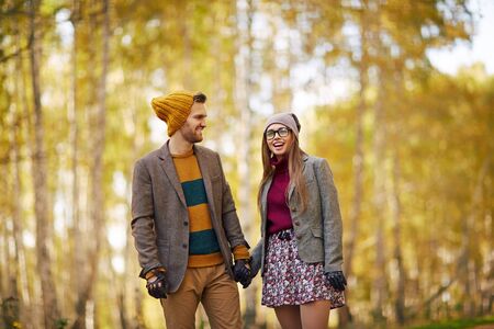 Happy couple in stylish clothes dating outdoors in autumnの写真素材