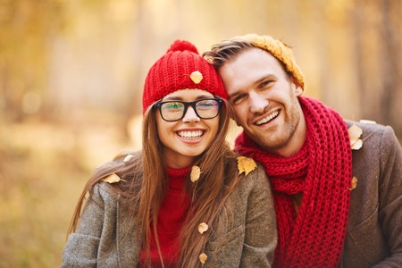 Happy young couple in leaf fall enjoying autumnの写真素材
