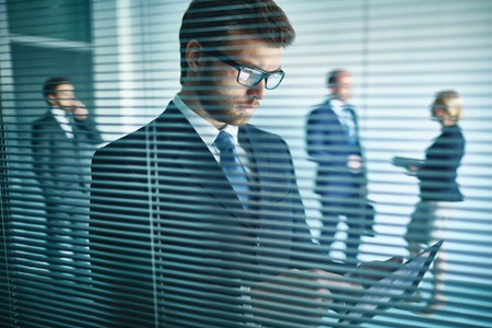 Young businessman using modern gadgetの写真素材