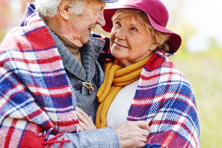 Retired couple in embrace looking at one another