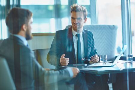 Young businessmen discussing working plans in office