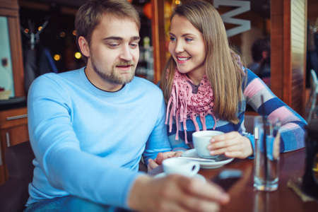 Romantic couple relaxing by cup of coffee