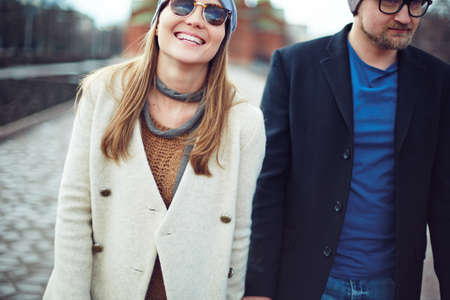 Happy girl and her sweetheart having walk
