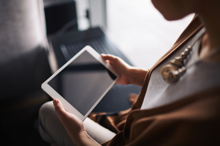 Touchpad in hands of a womanの写真素材