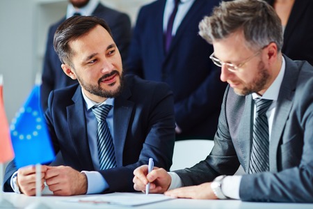 Asian businessman looking at his partner during negotiationの写真素材