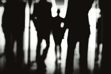 Business people walking down corridor of office centerの写真素材