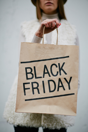 Young woman showing Black Friday paperbagの写真素材