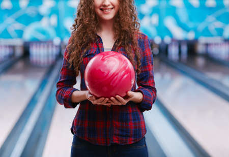 Woman with bowling ball in club