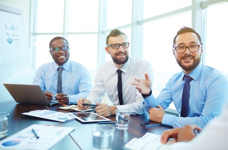 Group of young businessmen having discussion at meetingの写真素材