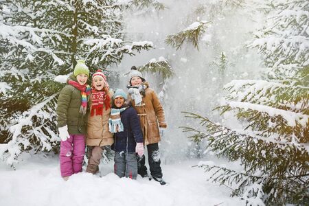 Cute little friends looking at camera in winter park