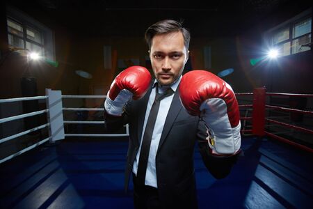 Serious man wearing boxing glovesの写真素材