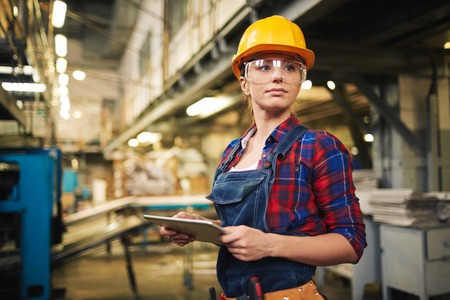 Young factory worker controlling the work