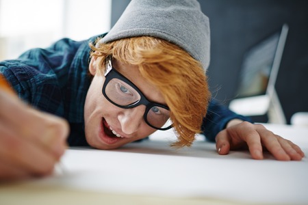 Happy young architect drawing sketch on paperの写真素材