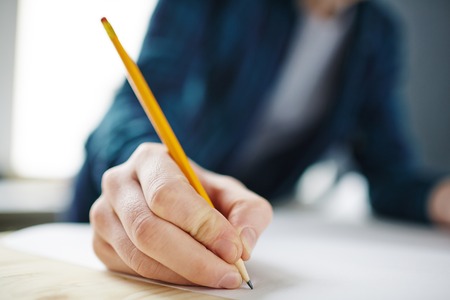 Hand of architect with pencil drawing sketch on paperの写真素材