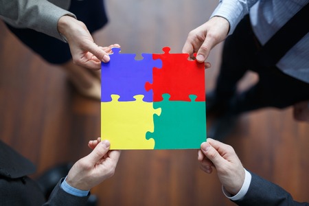 Multi-color puzzle pieces assembled by business teamの写真素材
