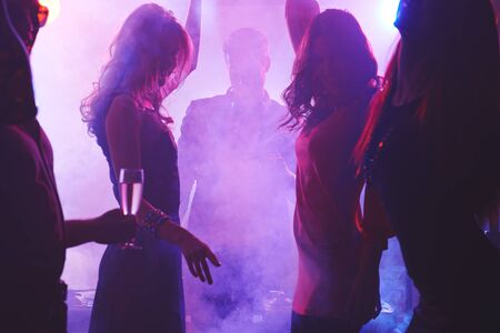 Group of dancing people in night clubの写真素材