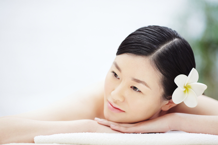 Asian woman relaxing in spa salonの写真素材