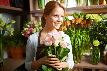 Portrait of pretty woman working in flower shopの写真素材