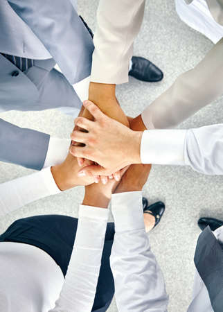 Businesspeople hands on top of each otherの写真素材