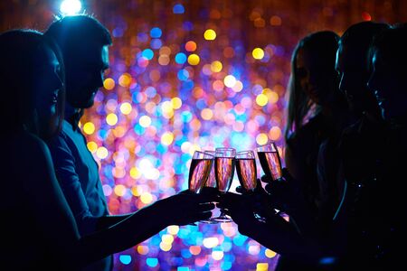 Group of happy friends toasting with champagne