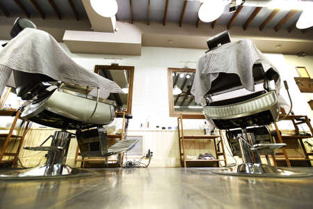View of barbershop interior with armchairs and mirrorsの写真素材