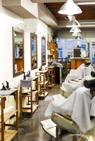 Barbershop room with professional equipment, armchairs and mirrorsの写真素材