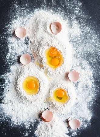 Close-up of flour and eggs on the tableの写真素材