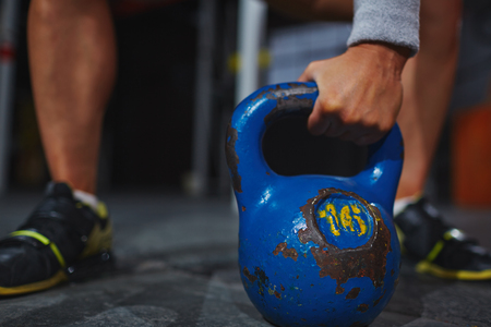Female hand lifting kettle in gymの写真素材
