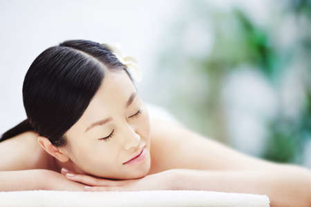 Beautiful girl lying on massage tableの写真素材