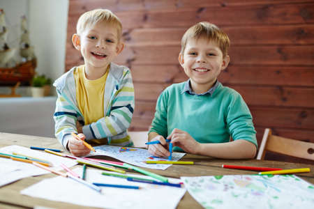 Adorable boys coloring pictures with highlighters at leisureの写真素材