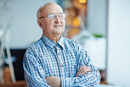 Elegant senior man in eyeglasses and shirtの写真素材