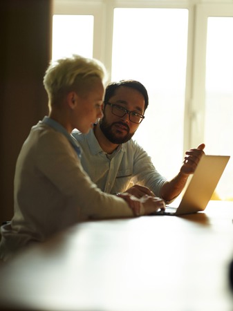 Asian businessman explaining data to co-worker at meetingの写真素材