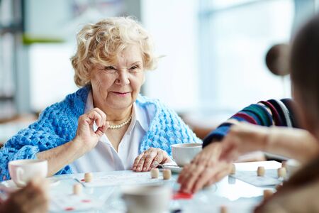 Senior woman playing lotto with friendsの写真素材