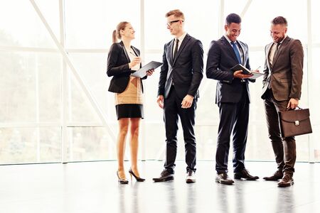 Business people standing and talkingの写真素材