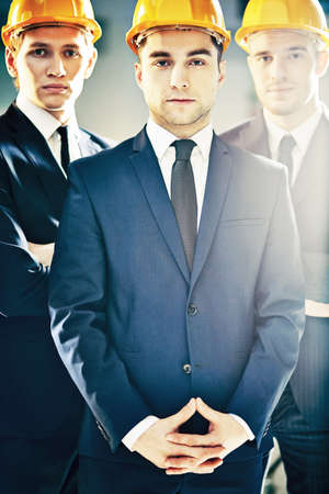 Confident team of three construction managers