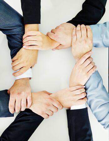 Joined hands of business team showing loyaltyの写真素材