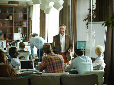 Business team having meeting in office, leader speaking to colleagues