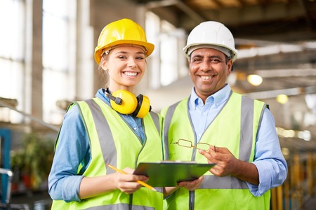 Experienced engineer with his young female traineeの写真素材