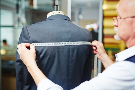 Tailor measuring width of jacket backの写真素材