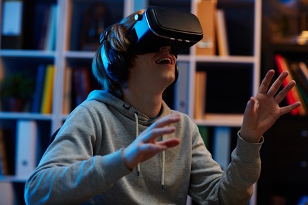Teenager using vr glasses at night