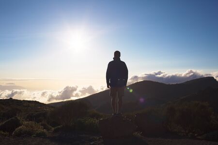 Young man admiring beautiful view of sky and mount