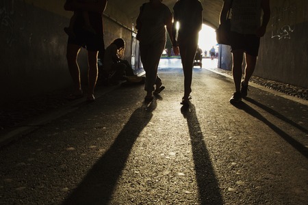 Passerbies walking inside tunnel in the street of a cityの写真素材