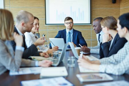Group of business people having meeting in a board room in an officeの写真素材