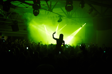 Crowd in front of bright stage lightsの写真素材